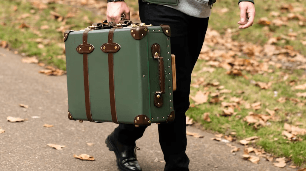 A close-up of a luxurious leather handbag resting on a marble surface with soft lighting accentuating its intricate craftsmanship